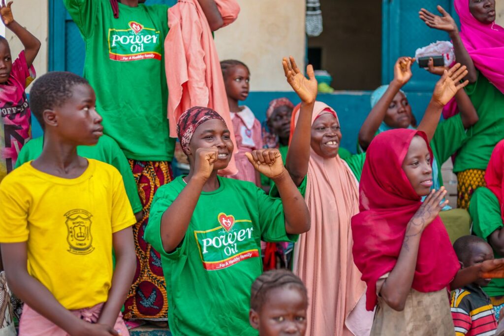 A vibrant scene of people celebrating joyfully on a city street, expressing unity and happiness.